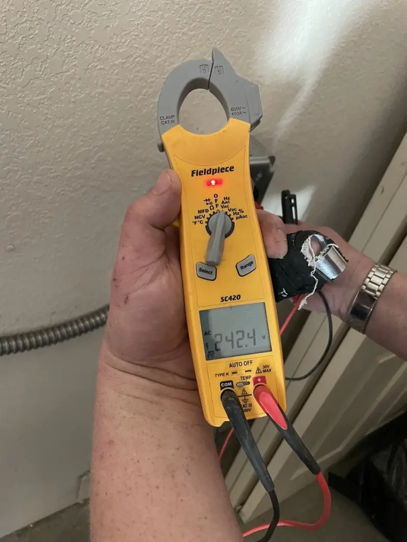 Voltage testing with clamp meter during Recessed Lighting Installation in Decatur